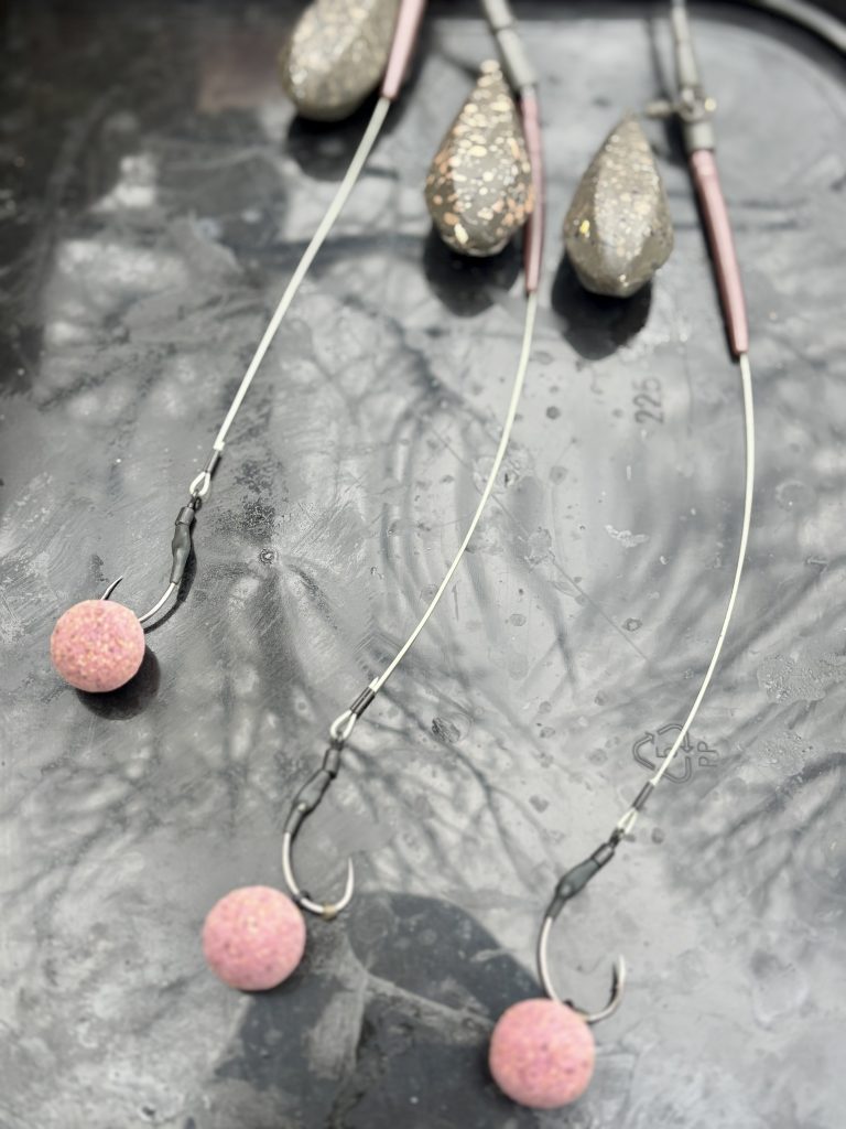 Carp spinner rigs baited with boilies showing hook and bait placement