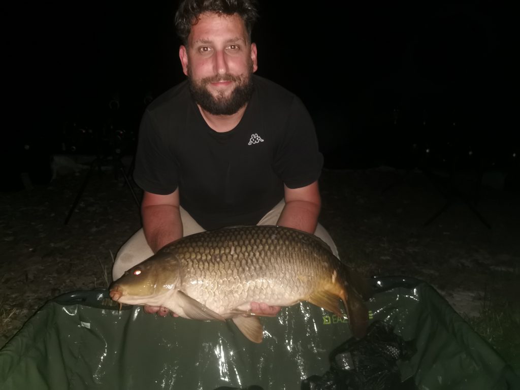Night carp fishing with a common carp caught after dark