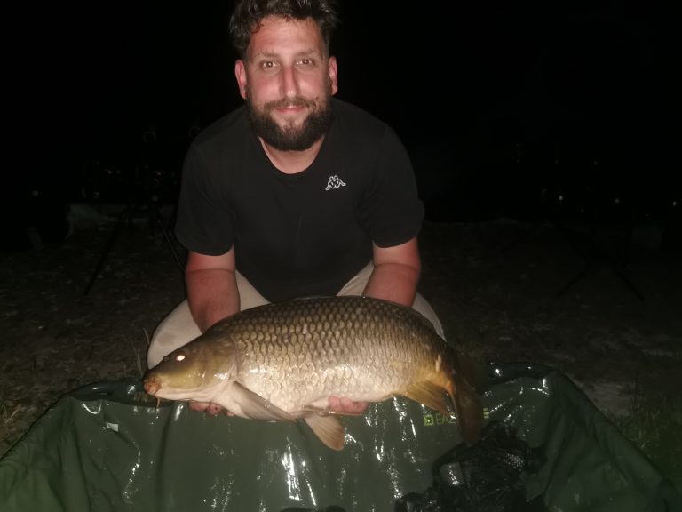 Night carp fishing with a common carp caught after dark
