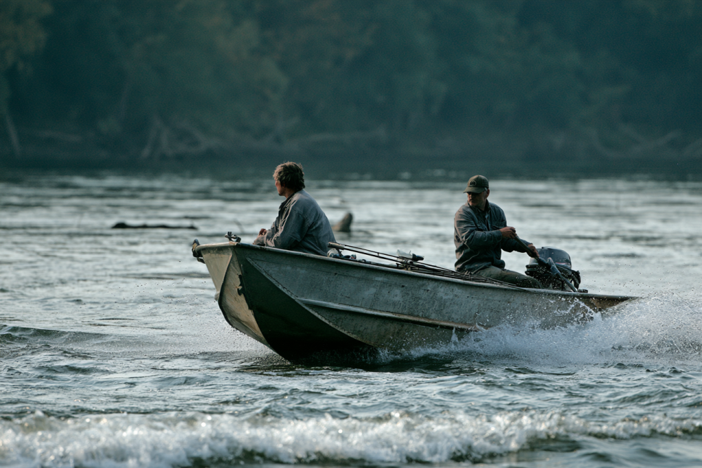 V-hull fishing boat travelling through river chop
