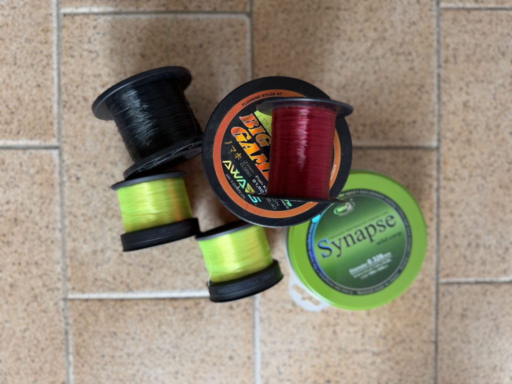 Different carp fishing line spools showing variations in line color and diameter