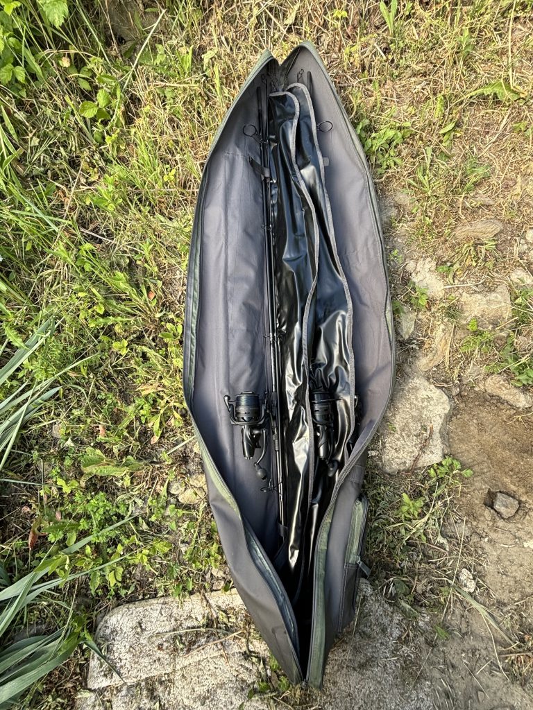Two-piece carp rods and reels packed inside a fishing rod bag