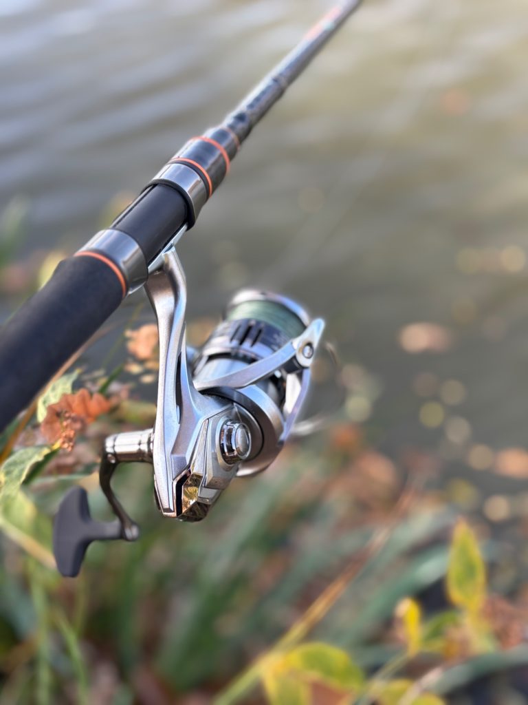 Simple spinning rod and reel setup beside the water for beginner fishing